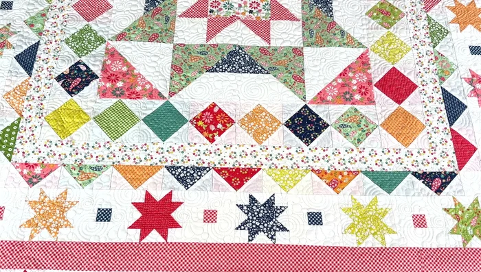 Add the first inner border (flower wreath blocks).