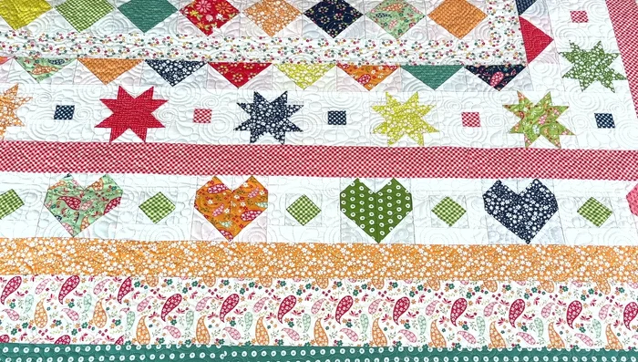 Add the heart blocks with interspersed diamonds.