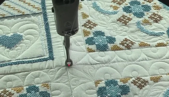 Add a final corner pattern freehand to complete the quilting.