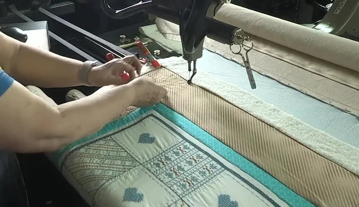 Start quilting the borders. The video uses a fill pattern that stabilizes the quilt.