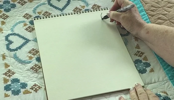 For smaller areas (like the turquoise section), use a simple, fast design like parallel loops to add quilting without obscuring the cross-stitch.