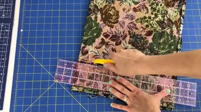 Fold fabric in half, curve the corners using a ruler or curved object, and cut to reduce bulk.