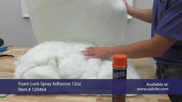 Carefully stuff the pillow cover with the prepared filling. Start by stuffing the bottom edge of the polyester batting into the cover, then add the rest.