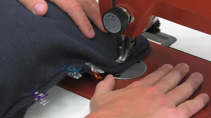 Sew the opening shut using the left roping zipper foot to sew close to the piping.