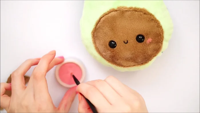 Apply blush to the cheeks.