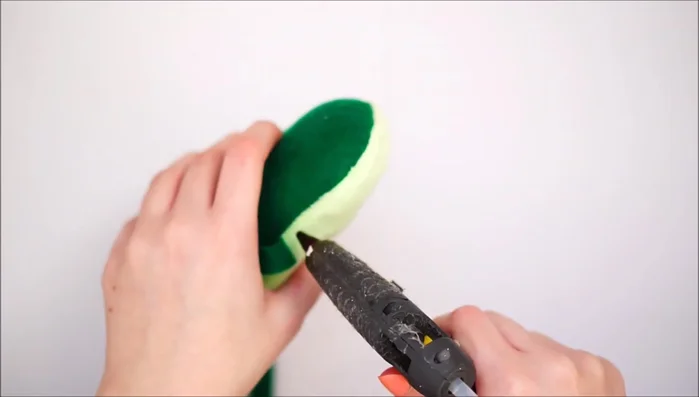 Glue green felt strips around the edges to add a darker green accent and conceal any imperfections.