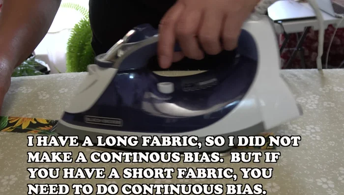 Make the binding. Measure quilt and cut fabric into 2.5-inch strips. If fabric is short, create a continuous bias. Fold in half and iron.