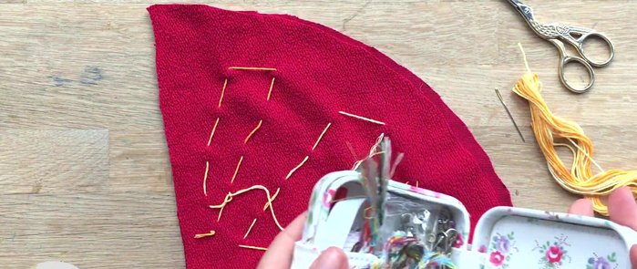 Fold the semicircle in half with the curved edge on the outside and sew a strong edge along the straight side using a back stitch.