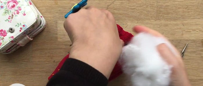 Stuff the strawberry firmly using stuffing or fabric scraps.