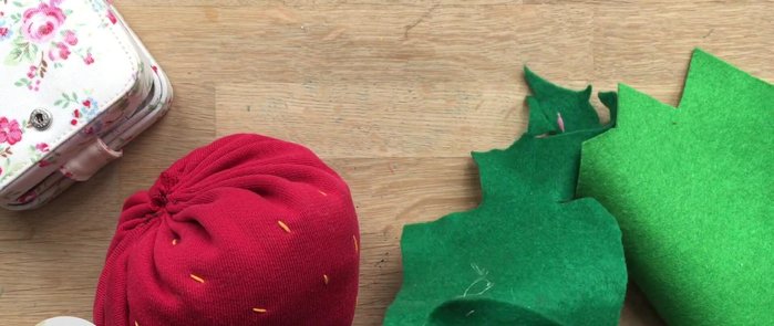 Cut out felt leaf shapes and sew or glue them onto the top of the strawberry.
