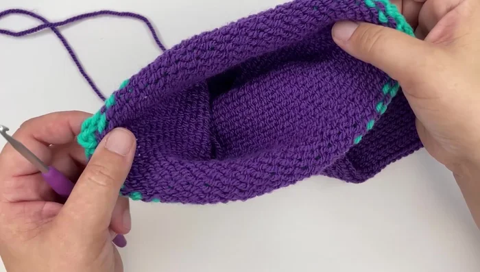 Using a crochet hook, slip stitch the two ends of the tube together to close it.