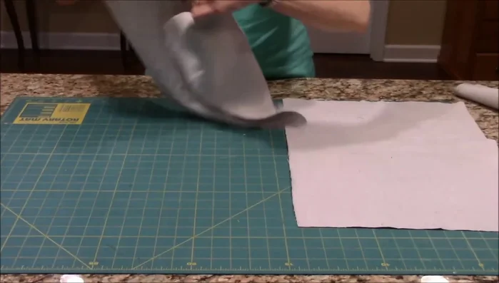 Create a narrow hem on each of the two backing pieces using your sewing machine.