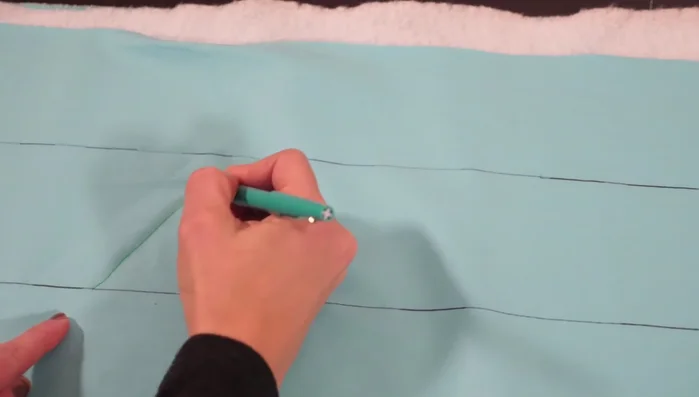 Continue by quilting another diagonal line across to the other side, creating an inverted triangle next to the first one.