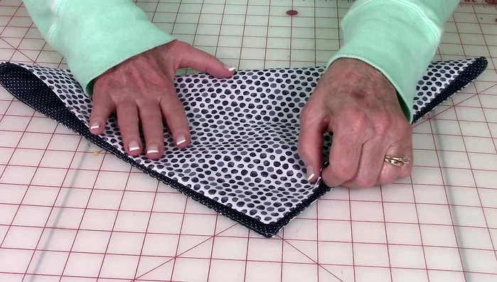 Stitch a few tack stitches at each pinned point to secure the folds.