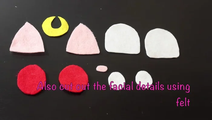 Cut out facial details (eyes, ears, nose, moon) from felt.