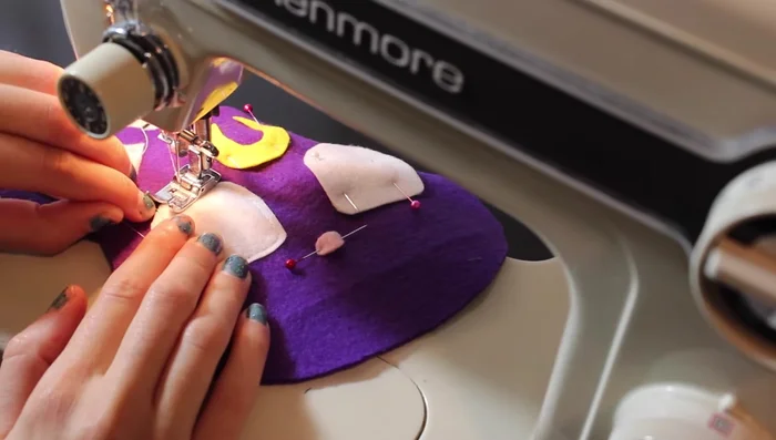 Pin the felt details to the front of the fabric.