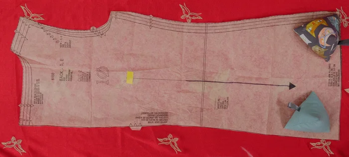 If a pattern needs to be placed on a fold, cut half, unfold, flip, and cut the other half to create a single whole piece.