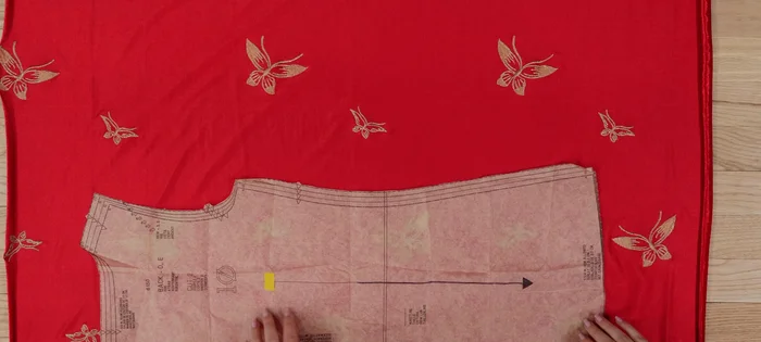 If a pattern needs to be placed on a fold, cut half, unfold, flip, and cut the other half to create a single whole piece.