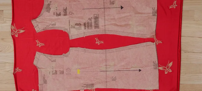 Lay out your fabric in a single layer on your cutting mat. Place the patterns in your preferred direction, referencing the arrow on your pattern pieces to ensure they're all going in the same direction. Consider the stretch – the direction with the greatest stretch should go around the body (perpendicular to the grain line arrow).