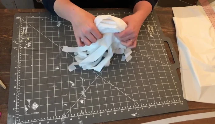 Cut about three or four inches from the three-quarter-inch piece saved earlier. Wrap this around the bottom of the loop and secure with glue. Do not pull too tightly.