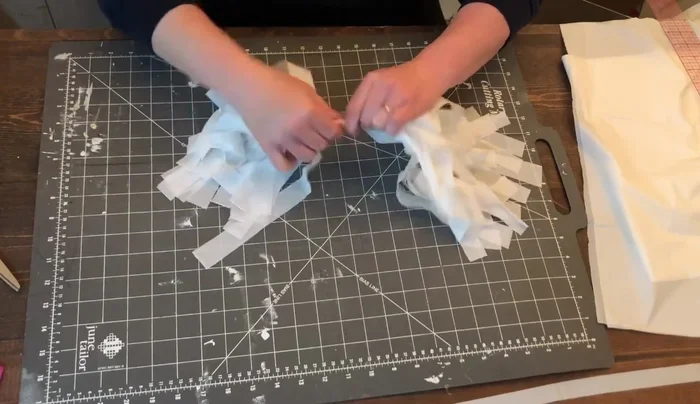 Cut about three or four inches from the three-quarter-inch piece saved earlier. Wrap this around the bottom of the loop and secure with glue. Do not pull too tightly.