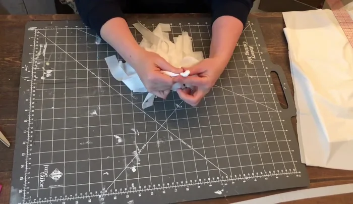 Cut about three or four inches from the three-quarter-inch piece saved earlier. Wrap this around the bottom of the loop and secure with glue. Do not pull too tightly.