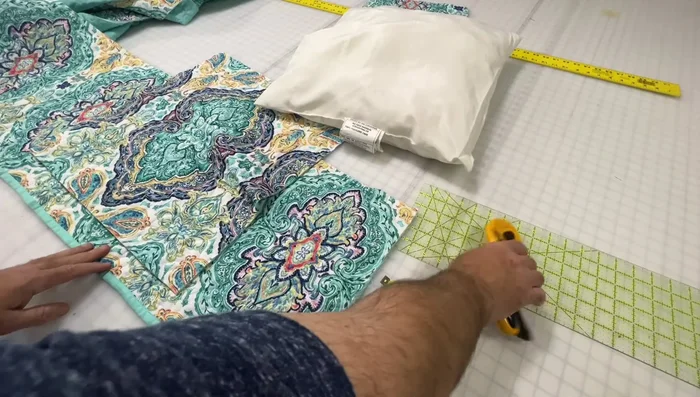 Cut envelope closure pieces: Cut two pie-shaped pieces from the quilt to create the envelope closure. Ensure the designs align when folded.