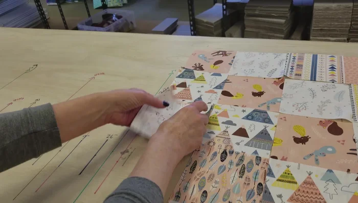 Stack and pin rows: Stack the rows of charm squares, ensuring they are right-side up and in the correct order. Use pins to secure them.