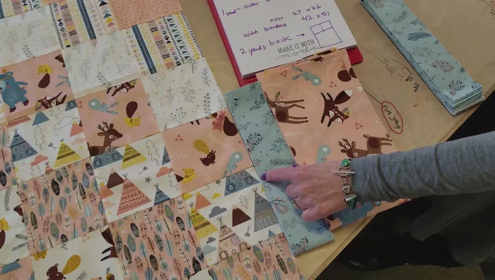 Add borders: Cut and sew on the chosen borders (inner and outer). A 2 1/2 inch inner border and 6-inch outer border are suggested in the video.