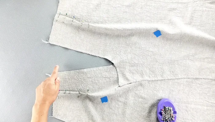 Press the darts towards the center back.