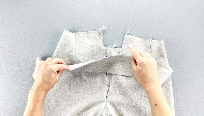 Press the waistband seam down.