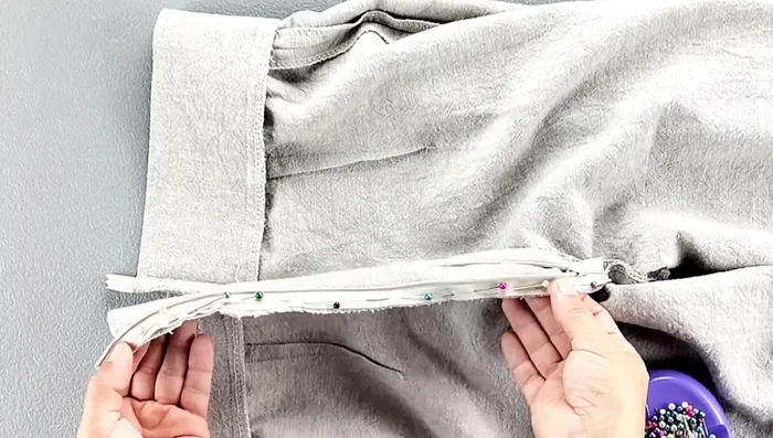 Fold and sew the zipper tape to the inside of the waistband.