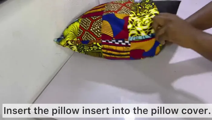 Insert the pillow insert into the cover. Zip closed.