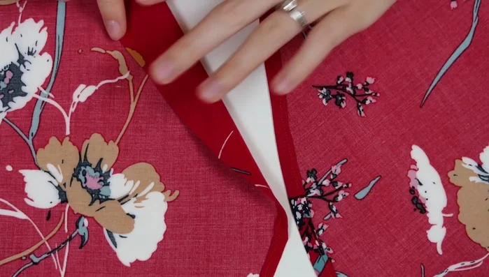 Tack the sleeves and sew snaps to the neckline for closure.