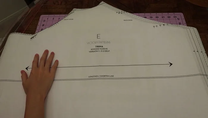 Create the alternative flounce sleeve pattern by folding the original sleeve pattern in half, marking the center, and drafting a 5/8 inch flounce on either side.
