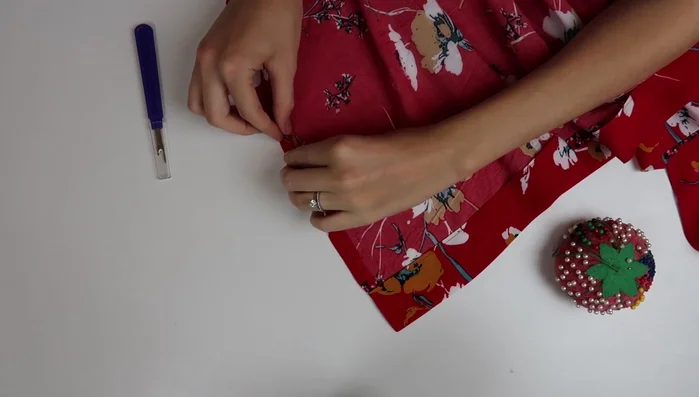 Tack the sleeves and sew snaps to the neckline for closure.