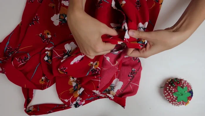 Tack the sleeves and sew snaps to the neckline for closure.