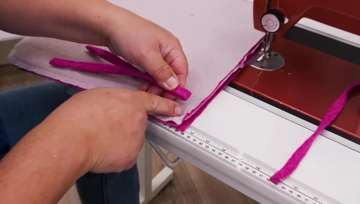 Insert fabric ties into the back corners of the chair pad, about an inch from the corner.