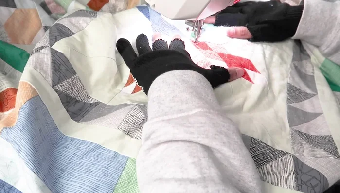 For medallion quilts, work on one block or round at a time. For regular quilts, complete one quarter before moving to the next.