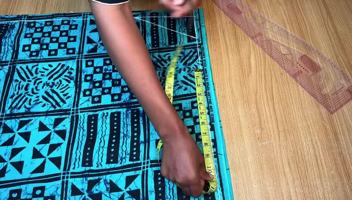 Cut the Front Pattern: Fold the neckline allowance before cutting to maintain length. Cut out the front pattern, separating it into two pieces at the center slit.