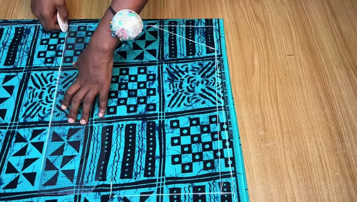 Cut the Front Pattern: Fold the neckline allowance before cutting to maintain length. Cut out the front pattern, separating it into two pieces at the center slit.