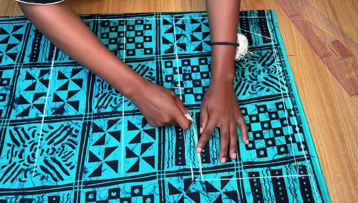 Cut the Front Pattern: Fold the neckline allowance before cutting to maintain length. Cut out the front pattern, separating it into two pieces at the center slit.