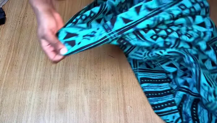 Drafting the Front Pattern: Mark a straight line at the top (shoulder line). From the center fold, mark 1 inch inward for the slit allowance. Draw the neckline, measuring 3 inches inward from the slit allowance line and 6.5 inches down for the neck depth.