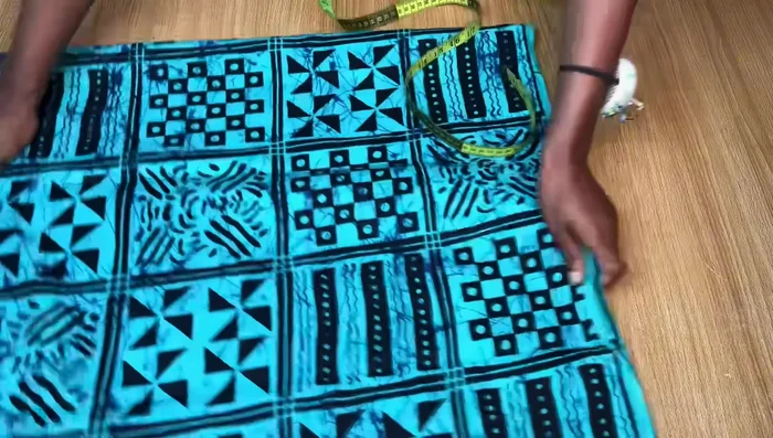 Drafting the Front Pattern: Mark a straight line at the top (shoulder line). From the center fold, mark 1 inch inward for the slit allowance. Draw the neckline, measuring 3 inches inward from the slit allowance line and 6.5 inches down for the neck depth.