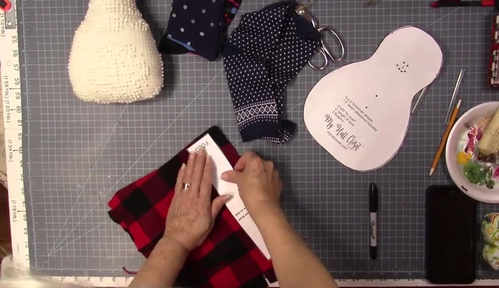 Prepare and glue the toboggan (from a sock) onto the snowman's head.