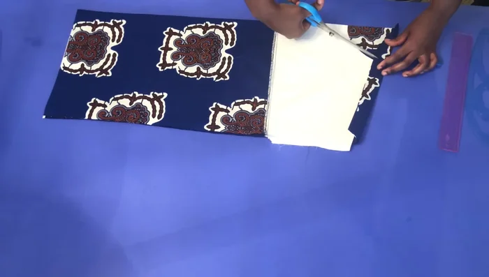 Create a small slit on the back piece, pull the front back, and measure 1 1/4 inches at the back before cutting.