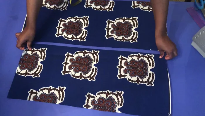 Create a small slit on the back piece, pull the front back, and measure 1 1/4 inches at the back before cutting.