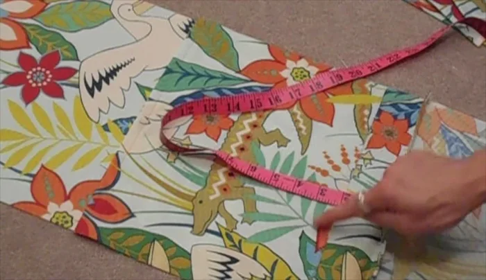 Measure 2 inches from the bottom seam of the back panel and pin a panel in place. Sew along the bottom 1/2 inch from the edge to secure.