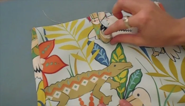 Create a small fabric loop for hanging; sew it to the middle of the right side (about 1/2 inch from the top).