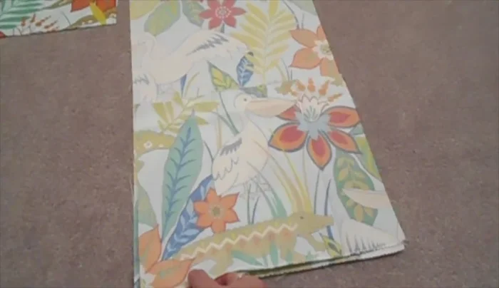 Measure 2 inches from the bottom seam of the back panel and pin a panel in place. Sew along the bottom 1/2 inch from the edge to secure.